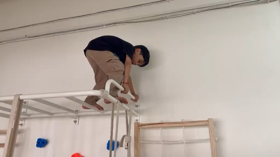 Video of a child climbing a rope net at Vasishtha School