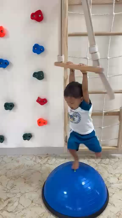 Child on a balance board at Vasishtha School